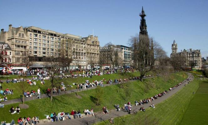 People sitting in the sun in East Princes Street Gardens. 